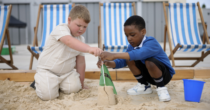 Two children playing in the sand at Locomotion's summer festival. Credit Locomotion Shildon.